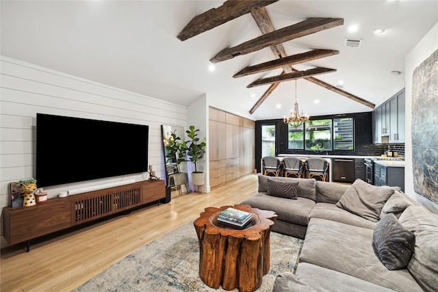406 Bomar St, Houston, TX 77006 - living room with a chandelier, beam ceiling, light wood-type flooring, and high vaulted ceiling
