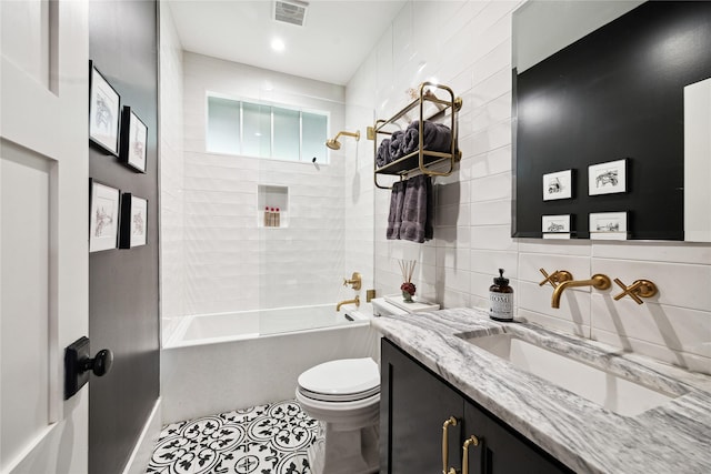 406 Bomar St, Houston, TX 77006 - full bathroom featuring vanity, washtub / shower combination, tile walls, tile patterned flooring, and recessed lighting