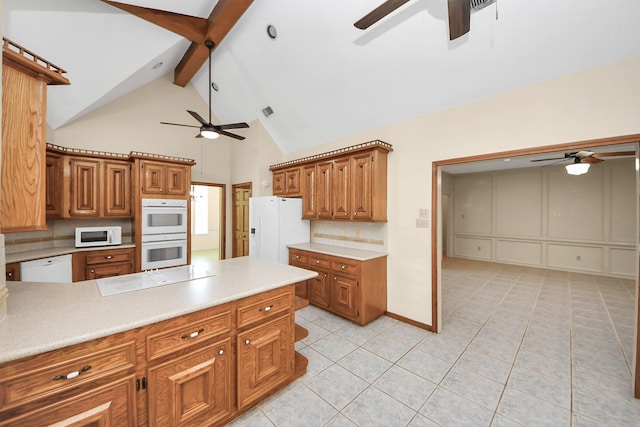 10503 Great Plains Ln, Houston, TX 77064 - kitchen with ceiling fan, white appliances, beamed ceiling, brown cabinets, and tasteful backsplash