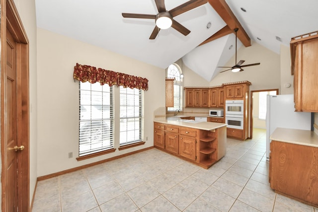 10503 Great Plains Ln, Houston, TX 77064 - kitchen featuring ceiling fan, white appliances, brown cabinets, light tile patterned floors, and light countertops
