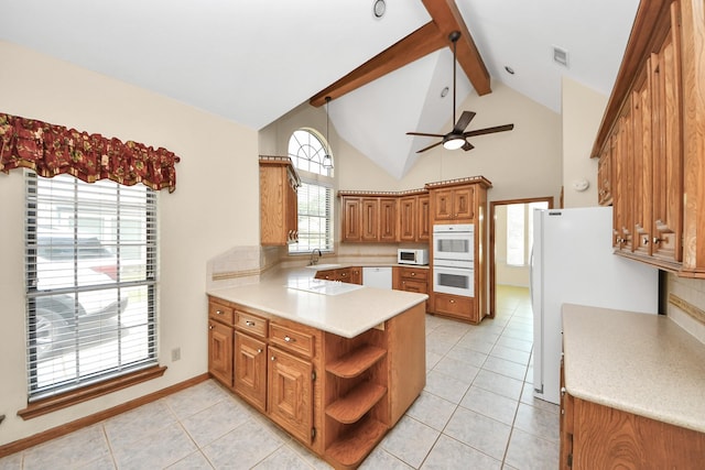 10503 Great Plains Ln, Houston, TX 77064 - kitchen with a peninsula, white appliances, brown cabinetry, beam ceiling, and backsplash