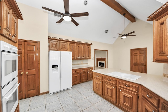 10503 Great Plains Ln, Houston, TX 77064 - kitchen with white appliances, ceiling fan, brown cabinetry, decorative backsplash, and beamed ceiling