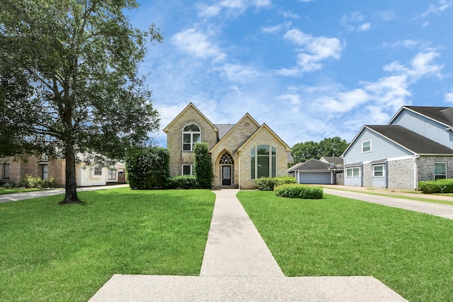 10503 Great Plains Ln, Houston, TX 77064 - view of front of property with a garage, driveway, a front yard, stone siding, and brick siding