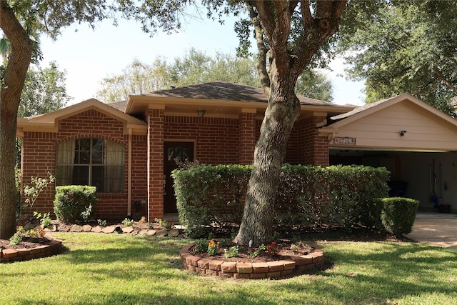 1714 Oak Ridge Dr, Kemah, TX 77565 - ranch-style home featuring brick siding, a garage, a front lawn, and concrete driveway