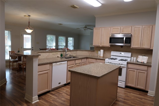 1714 Oak Ridge Dr, Kemah, TX 77565 - kitchen with white appliances, a peninsula, crown molding, dark wood-style floors, and light brown cabinets