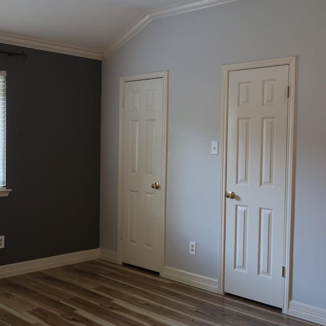 1714 Oak Ridge Dr, Kemah, TX 77565 - unfurnished bedroom with ornamental molding, dark wood-style flooring, and lofted ceiling