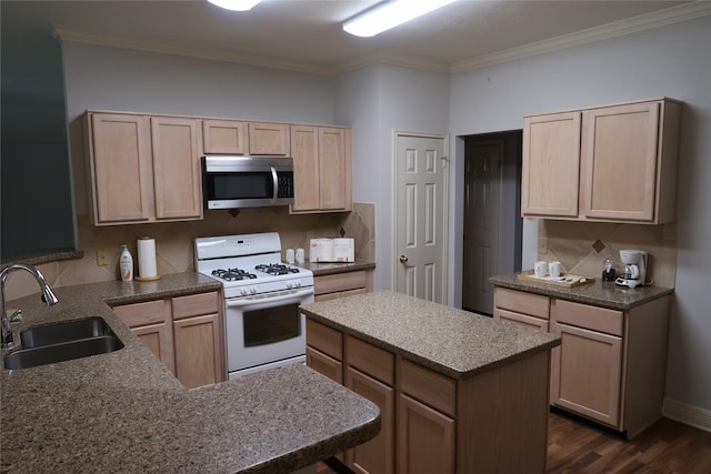 1714 Oak Ridge Dr, Kemah, TX 77565 - kitchen with stainless steel microwave, white range with gas cooktop, light brown cabinetry, crown molding, and dark wood-type flooring