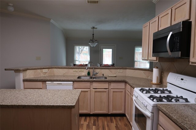 1714 Oak Ridge Dr, Kemah, TX 77565 - kitchen with white appliances, a peninsula, light brown cabinetry, wood finished floors, and ornamental molding