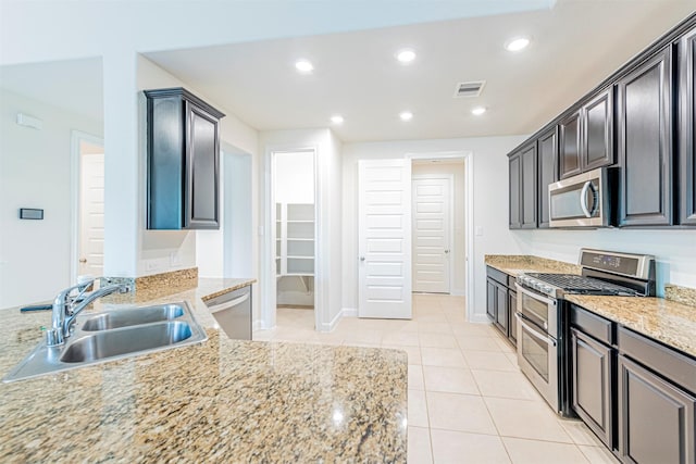 12610 Marley Hills Trl, Houston, TX 77089 - kitchen with appliances with stainless steel finishes, light tile patterned floors, light stone counters, and recessed lighting