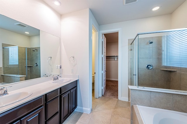 12610 Marley Hills Trl, Houston, TX 77089 - bathroom with a stall shower, tile patterned flooring, double vanity, a garden tub, and a walk in closet