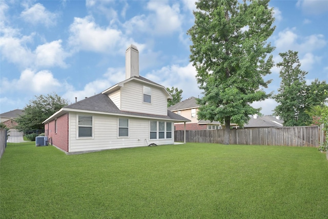 31 Hearthwick Rd, Tomball, TX 77375 - rear view of house with a fenced backyard, a chimney, and roof with shingles