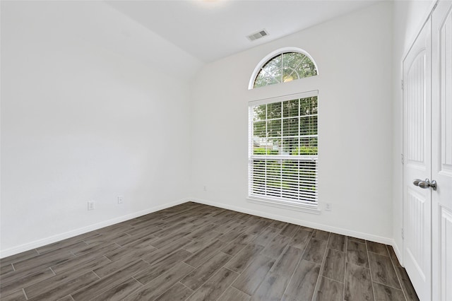 31 Hearthwick Rd, Tomball, TX 77375 - spare room with dark wood-type flooring and lofted ceiling