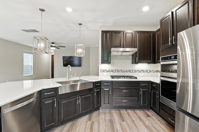 8618 Cedar Plains Ln, Houston, TX 77080 - kitchen with stainless steel appliances, ceiling fan, under cabinet range hood, light countertops, and recessed lighting