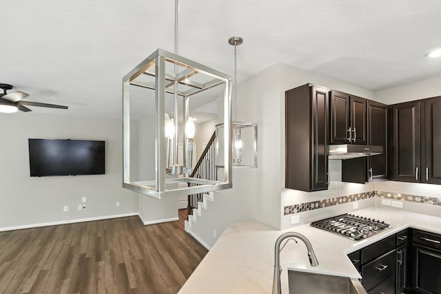 8618 Cedar Plains Ln, Houston, TX 77080 - kitchen featuring stainless steel gas cooktop, under cabinet range hood, light countertops, dark wood-style flooring, and a ceiling fan