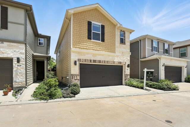 8618 Cedar Plains Ln, Houston, TX 77080 - contemporary house featuring stone siding, a garage, and concrete driveway