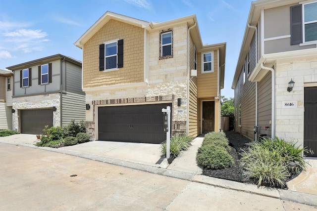8618 Cedar Plains Ln, Houston, TX 77080 - view of front of house with stone siding, a garage, and concrete driveway