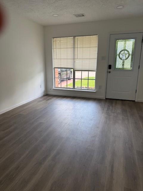 229 S Fulton St S, Texas City, TX 77591 - foyer entrance with dark wood finished floors and a textured ceiling