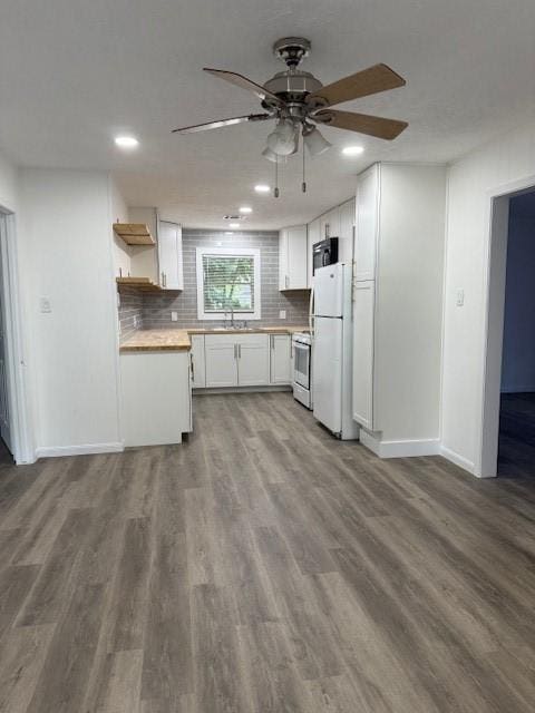 229 S Fulton St S, Texas City, TX 77591 - kitchen with freestanding refrigerator, range, open shelves, ceiling fan, and white cabinetry