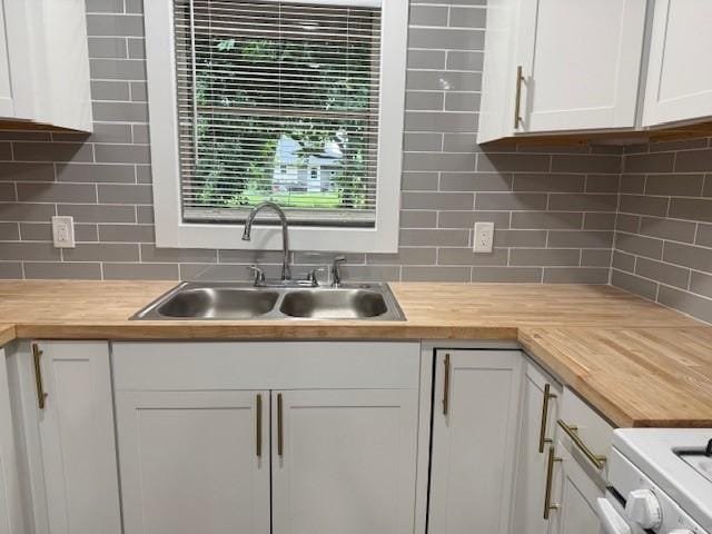 229 S Fulton St S, Texas City, TX 77591 - kitchen with butcher block counters, white cabinetry, and backsplash