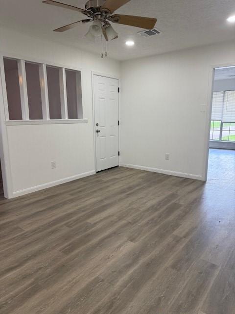 229 S Fulton St S, Texas City, TX 77591 - spare room featuring dark wood finished floors, ceiling fan, and recessed lighting