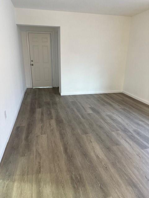 229 S Fulton St S, Texas City, TX 77591 - spare room featuring dark wood-type flooring