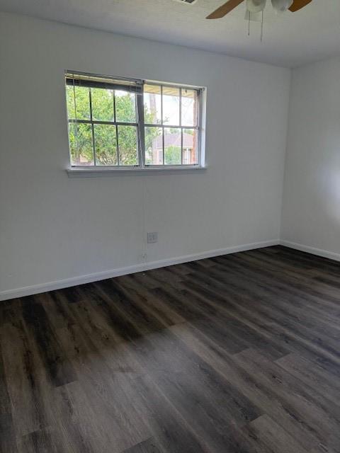 229 S Fulton St S, Texas City, TX 77591 - unfurnished room featuring plenty of natural light, a ceiling fan, and dark wood-type flooring
