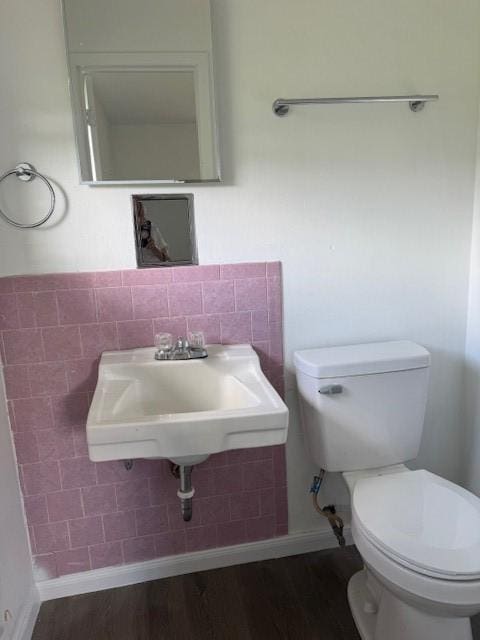 229 S Fulton St S, Texas City, TX 77591 - bathroom featuring toilet and wood finished floors