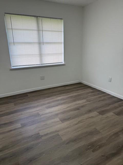 229 S Fulton St S, Texas City, TX 77591 - spare room featuring dark wood finished floors and baseboards