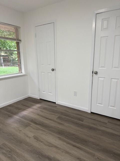 229 S Fulton St S, Texas City, TX 77591 - unfurnished bedroom with dark wood-type flooring and baseboards
