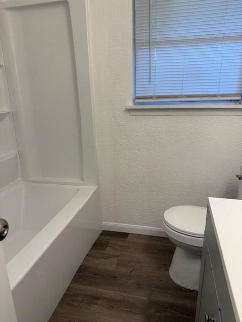 229 S Fulton St S, Texas City, TX 77591 - bathroom with wood finished floors, vanity, washtub / shower combination, and a textured wall
