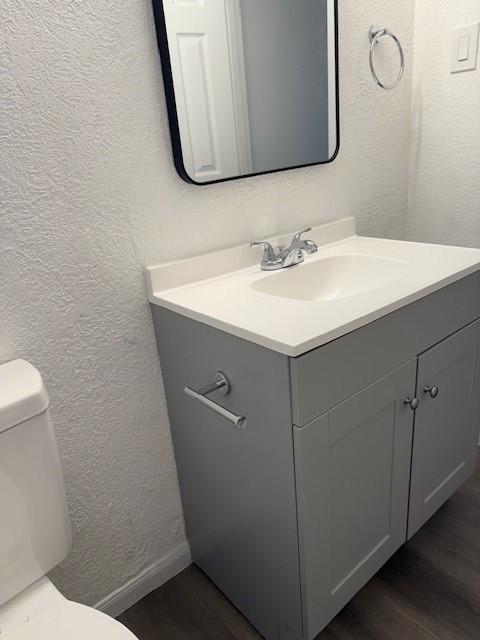 229 S Fulton St S, Texas City, TX 77591 - half bath featuring vanity, wood finished floors, and a textured wall