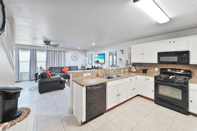 8011 Sumal Cir, Baytown, TX 77521 - kitchen with black appliances, a textured ceiling, a peninsula, white cabinetry, and open floor plan