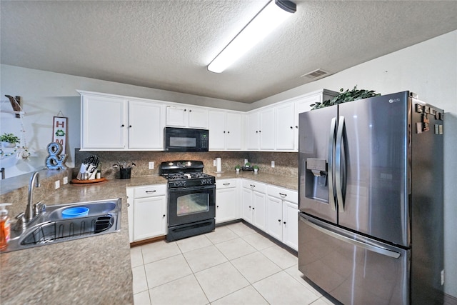 8011 Sumal Cir, Baytown, TX 77521 - kitchen with black appliances, a textured ceiling, white cabinetry, decorative backsplash, and light tile patterned floors