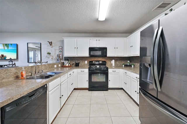 8011 Sumal Cir, Baytown, TX 77521 - kitchen featuring black appliances, a textured ceiling, white cabinets, decorative backsplash, and light countertops
