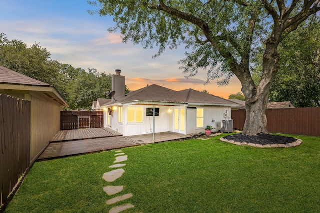 12226 Westwold Dr, Tomball, TX 77377 - back of house with a chimney, a fenced backyard, and a wooden deck