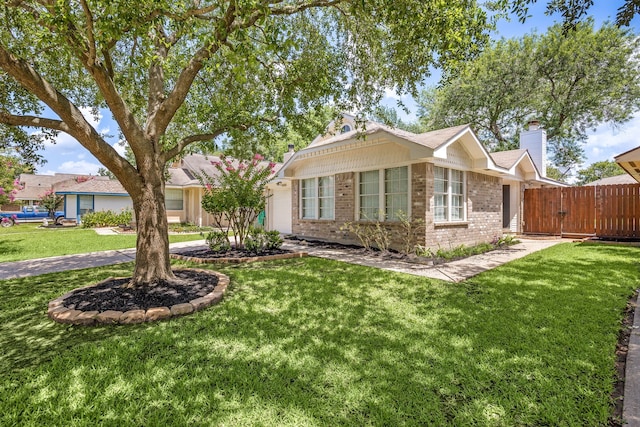 12226 Westwold Dr, Tomball, TX 77377 - ranch-style house with brick siding, a front lawn, a chimney, and a gate