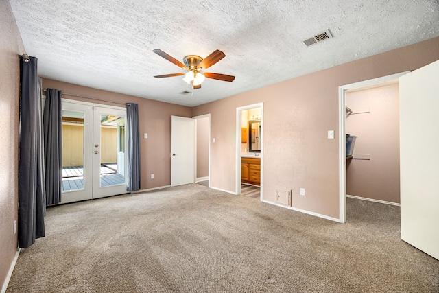 12226 Westwold Dr, Tomball, TX 77377 - unfurnished bedroom with french doors, access to outside, carpet, ensuite bathroom, and a textured ceiling