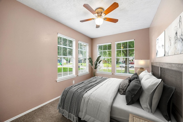 12226 Westwold Dr, Tomball, TX 77377 - carpeted bedroom featuring a ceiling fan and a textured ceiling