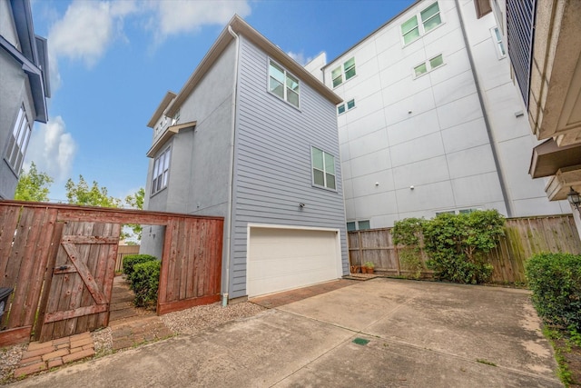 1219 Hickory St, Houston, TX 77007 - view of home's exterior with a garage and concrete driveway