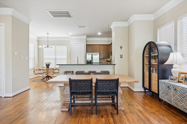 1219 Hickory St, Houston, TX 77007 - dining room with a chandelier, wood finished floors, recessed lighting, and ornamental molding