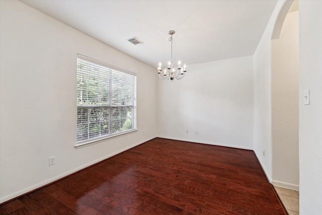 15 Sheltered Arbor Ct, The Woodlands, TX 77382 - empty room with a chandelier, wood finished floors, and arched walkways