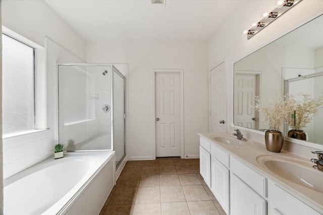 15 Sheltered Arbor Ct, The Woodlands, TX 77382 - full bathroom featuring double vanity, a stall shower, a garden tub, and tile patterned floors