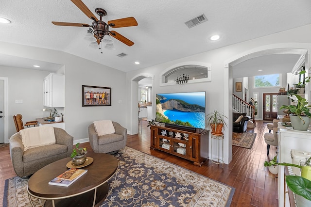 8639 Ballinger Dr, Houston, TX 77064 - living area with arched walkways, a ceiling fan, vaulted ceiling, dark wood finished floors, and recessed lighting