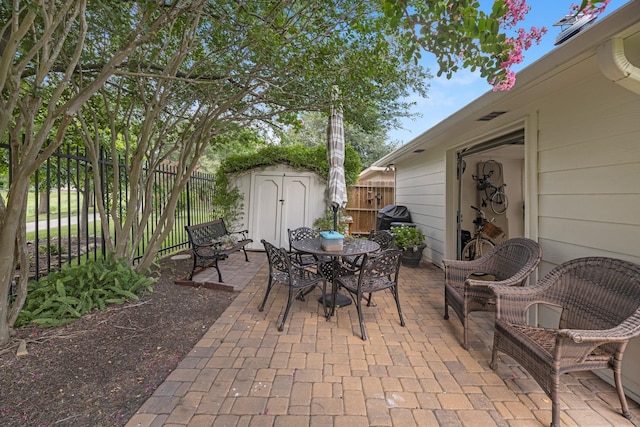 8639 Ballinger Dr, Houston, TX 77064 - view of patio featuring a shed and outdoor dining space