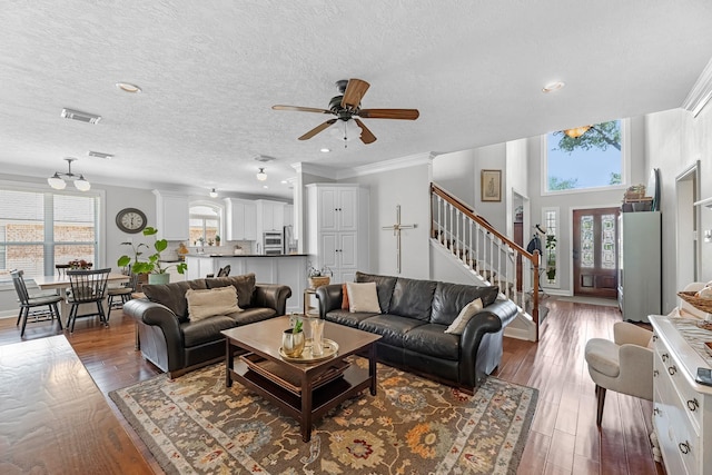 8639 Ballinger Dr, Houston, TX 77064 - living area with healthy amount of natural light, stairway, ceiling fan, wood finished floors, and a textured ceiling