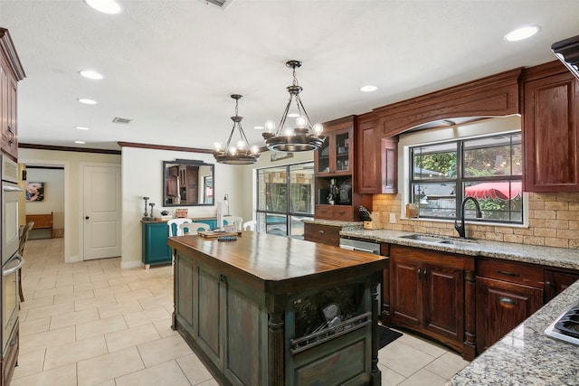 1025 Creek Bnd, Jasper, TX 75951 - kitchen with butcher block counters, decorative backsplash, a chandelier, a kitchen island, and recessed lighting