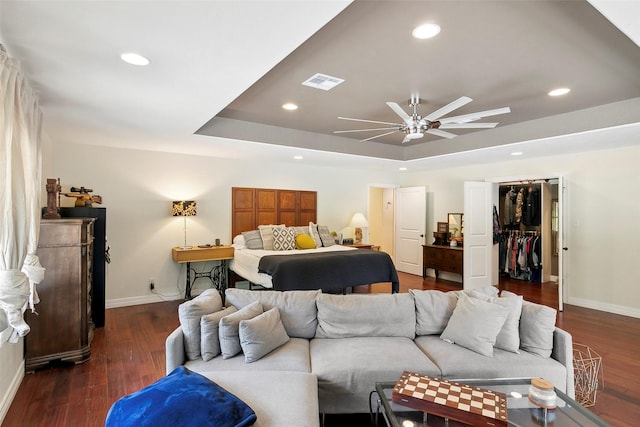 1025 Creek Bnd, Jasper, TX 75951 - bedroom with a tray ceiling, dark wood finished floors, recessed lighting, a closet, and a walk in closet