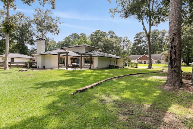 1025 Creek Bnd, Jasper, TX 75951 - rear view of house with a chimney, a patio, and brick siding