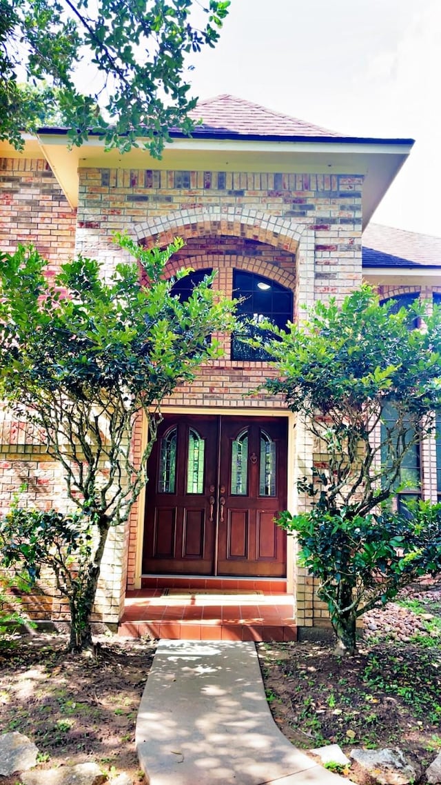 1600 Azalea St, Sweeny, TX 77480 - doorway to property featuring brick siding and a balcony