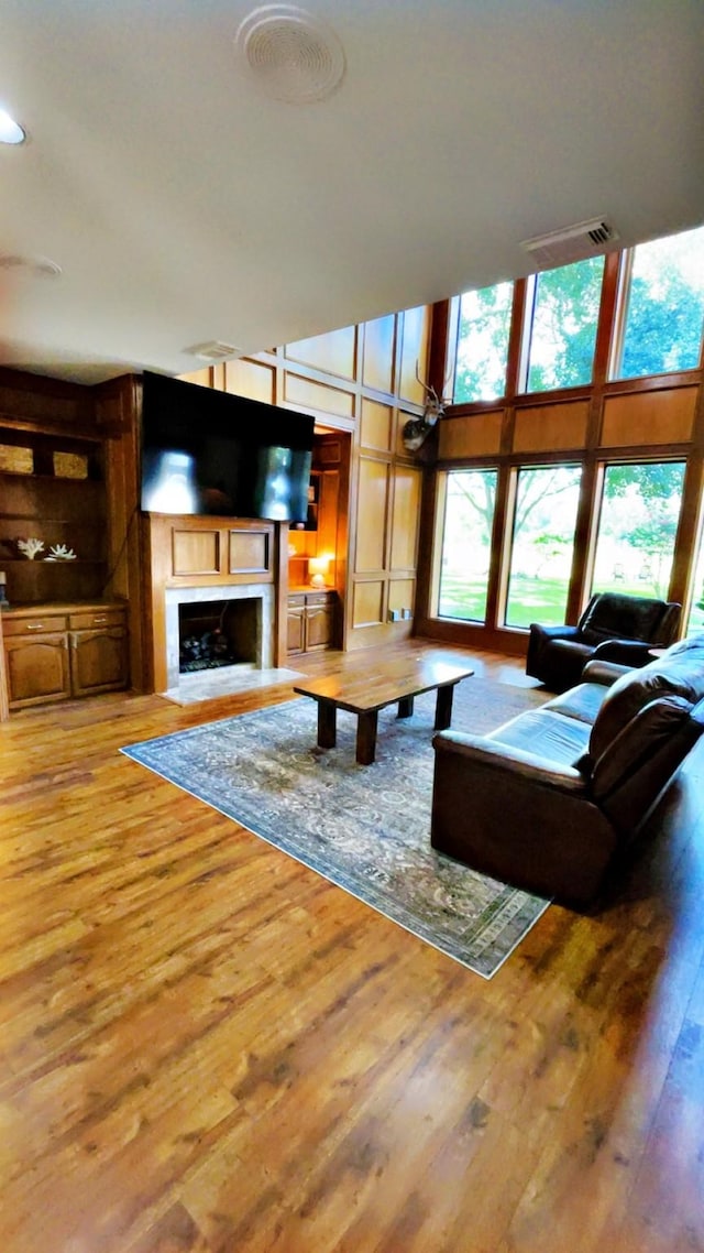1600 Azalea St, Sweeny, TX 77480 - living area featuring wood finished floors, a fireplace, and a high ceiling